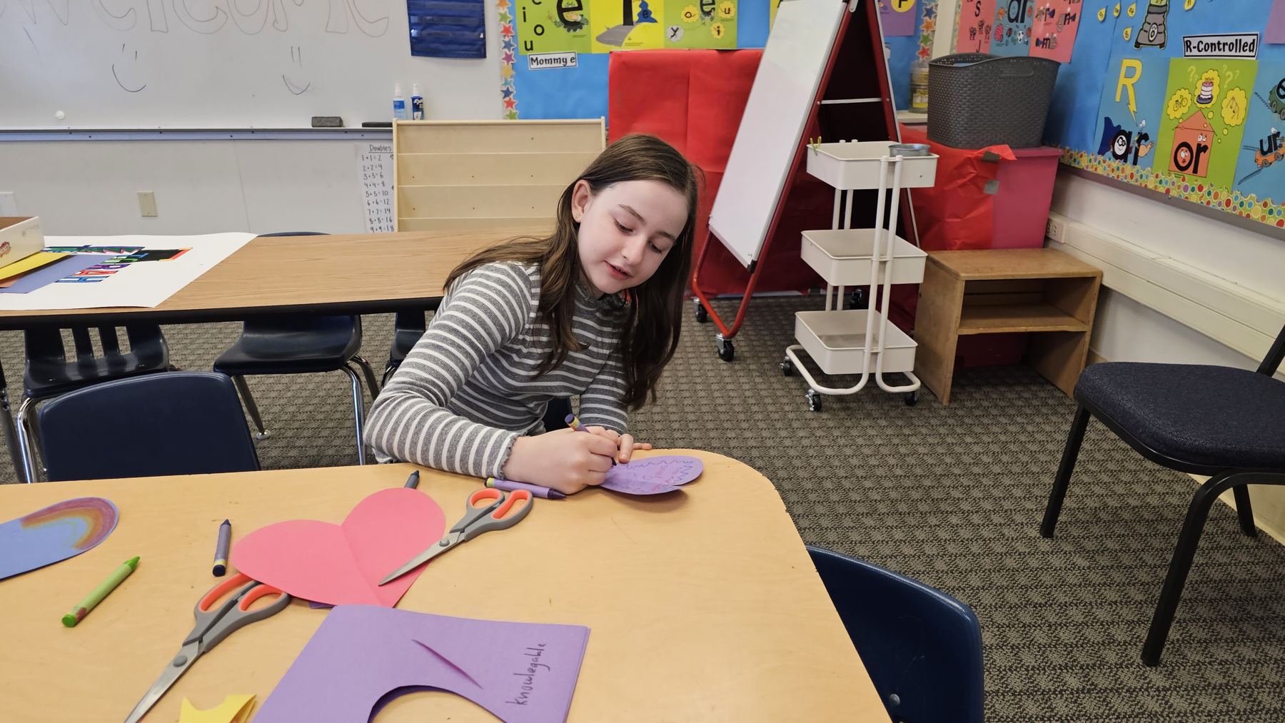 Girl making paper hearts