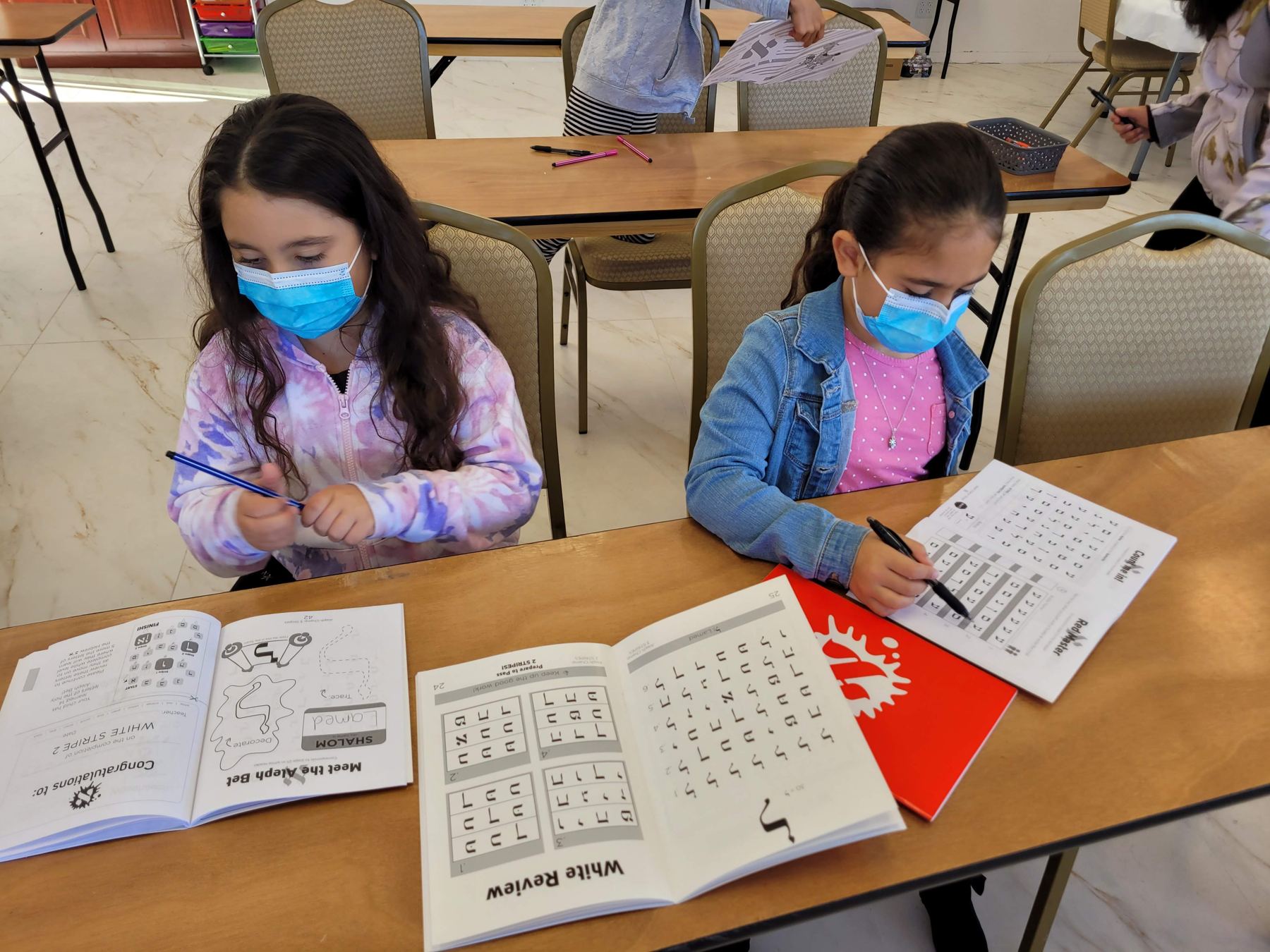 Girls with hebrew workbooks
